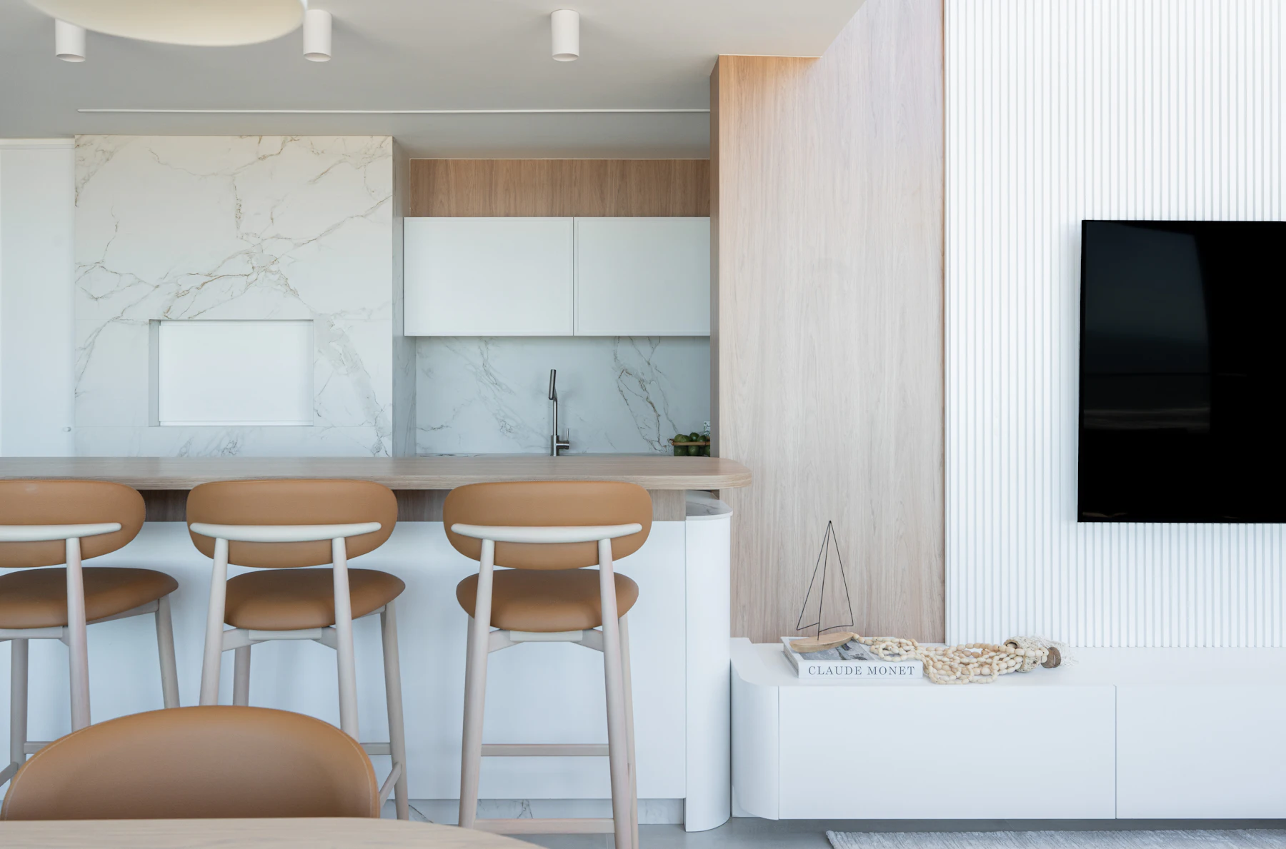 A contemporary apartment kitchen and living space