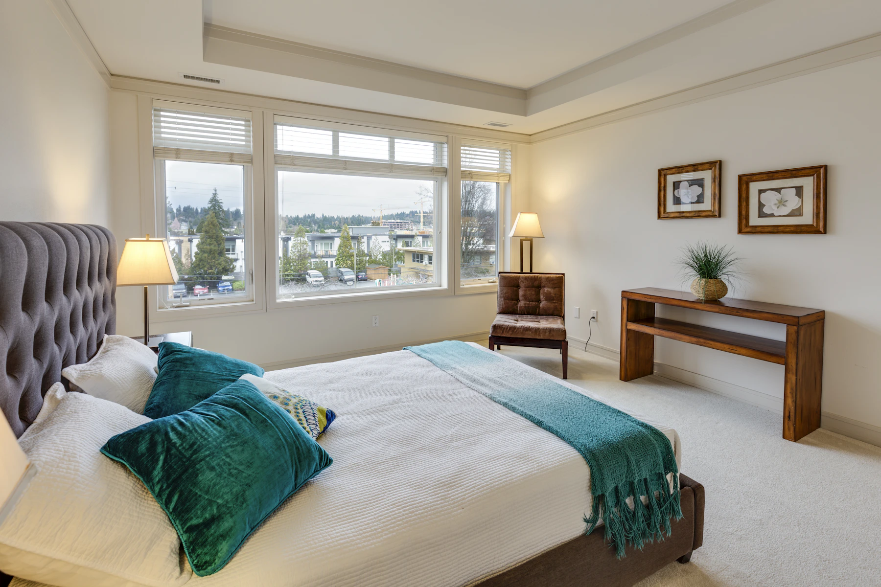 A bright bedroom with teal cushions
